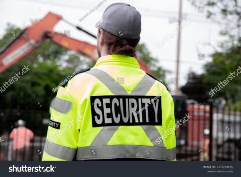 Stock Photo A Security Guard Patrolling The Street Next To The Construction Area 2235238025