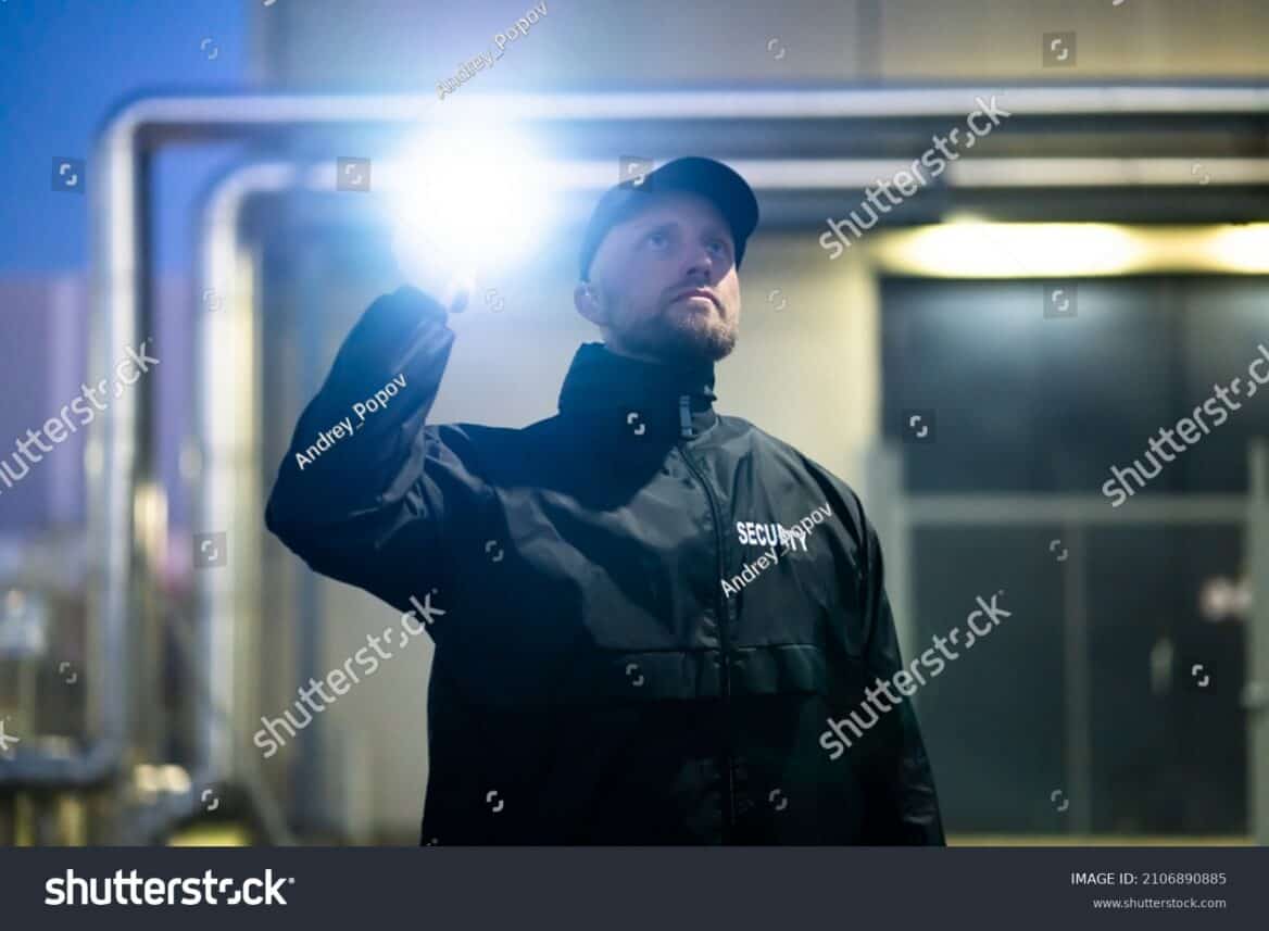 Stock Photo Security Guard Walking Building Perimeter With Flashlight At Night 2106890885